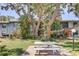 Exterior common area features picnic table and mature trees with view of buildings at 11800 Park Blvd # 208, Seminole, FL 33772