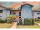 Charming two-story condo with vibrant landscaping and a welcoming entrance at 11800 Park Blvd # 208, Seminole, FL 33772