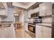 Well-equipped kitchen with stainless steel appliances and stylish countertops at 11800 Park Blvd # 208, Seminole, FL 33772