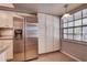 Bright kitchen featuring stainless steel refrigerator and ample cabinet space at 11800 Park Blvd # 208, Seminole, FL 33772