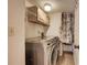 Laundry room includes side-by-side washer/dryer and storage cabinet at 11800 Park Blvd # 208, Seminole, FL 33772