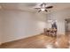 Bright and airy living room with hardwood floors, a ceiling fan, and dining area at 11800 Park Blvd # 208, Seminole, FL 33772