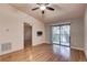 Bright living room with hardwood floors and sliding glass doors to a balcony at 11800 Park Blvd # 208, Seminole, FL 33772