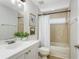 Well-lit bathroom featuring tile accents, white vanity with sleek fixtures, and shower-tub combo at 11938 Royce Waterford Cir, Tampa, FL 33626