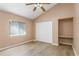 Bright bedroom with vaulted ceiling, featuring wood floors, closet and a window letting in natural light at 11938 Royce Waterford Cir, Tampa, FL 33626