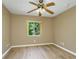 Neutral bedroom with light wood floors, standard window, and ceiling fan at 11938 Royce Waterford Cir, Tampa, FL 33626