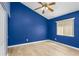 Empty bedroom with hard floors and blue accent wall at 11938 Royce Waterford Cir, Tampa, FL 33626