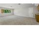 Expansive bonus room with plush carpet and window bringing in natural light at 11938 Royce Waterford Cir, Tampa, FL 33626