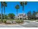 Elegant clubhouse exterior featuring stately architecture, lush landscaping, and a circular driveway, creating a grand entrance at 11938 Royce Waterford Cir, Tampa, FL 33626