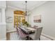 Elegant dining room featuring a modern chandelier, hardwood floors, and seating for six at 11938 Royce Waterford Cir, Tampa, FL 33626
