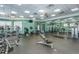 The gym area has a variety of exercise equipment, neutral-colored walls and ceilings, and a large mirror on the back wall at 11938 Royce Waterford Cir, Tampa, FL 33626