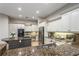 Bright kitchen features granite countertops, stainless appliances, and white cabinets at 11938 Royce Waterford Cir, Tampa, FL 33626