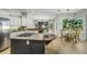 Kitchen with a gray center island and stainless appliances overlooks the breakfast nook at 11938 Royce Waterford Cir, Tampa, FL 33626