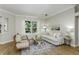 Bright living room with hardwood floors, modern furniture, and a beautiful view to the backyard at 11938 Royce Waterford Cir, Tampa, FL 33626