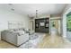 Spacious living room features a large sofa and custom built-in shelving at 11938 Royce Waterford Cir, Tampa, FL 33626