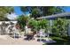 Landscaped backyard with brick patio area, four chairs and fire pit at 12176 Croft Dr, Largo, FL 33774