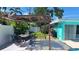 Inviting backyard patio featuring a dining area, pergola, grill, hammock, and swimming pool for outdoor entertaining at 12176 Croft Dr, Largo, FL 33774