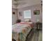 Cozy bedroom featuring a nautical theme, ceiling fan, and hardwood flooring at 12176 Croft Dr, Largo, FL 33774
