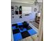 Functional bedroom area featuring an open floor, blue flooring, with room for exercise equipment at 12176 Croft Dr, Largo, FL 33774