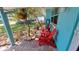 Cozy front porch adorned with vibrant red chairs, offering a perfect spot for relaxation at 12176 Croft Dr, Largo, FL 33774