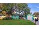 Charming home featuring vibrant curb appeal, complemented by lush landscaping and a welcoming driveway at 12176 Croft Dr, Largo, FL 33774