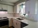 Updated kitchen featuring white cabinets, stylish backsplash and stainless steel appliances at 12176 Croft Dr, Largo, FL 33774