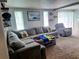 Comfortable living room with a large sectional sofa, throw pillows, and natural light at 12176 Croft Dr, Largo, FL 33774