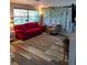 Bright living room featuring hardwood flooring, a large window, and comfortable seating at 12176 Croft Dr, Largo, FL 33774