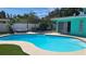 Private backyard pool with a relaxing hammock, outdoor seating, and lush landscaping at 12176 Croft Dr, Largo, FL 33774