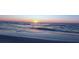 Gorgeous sunset over the ocean, casting a warm glow on the water and creating a tranquil scene at 12176 Croft Dr, Largo, FL 33774