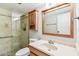 Updated bathroom with wooden vanity, framed mirror, and glass enclosed shower at 13501 Palmwood Ln # 0, Tampa, FL 33618