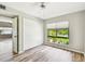 Bright bedroom features hardwood floors, large closet, and natural light at 13501 Palmwood Ln # 0, Tampa, FL 33618