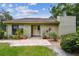 Charming single-story home with a brick-paved entrance and well-maintained landscaping at 13501 Palmwood Ln # 0, Tampa, FL 33618