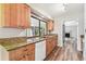 Galley kitchen with wood cabinets, granite countertops, stainless steel sink and modern appliances at 13501 Palmwood Ln # 0, Tampa, FL 33618