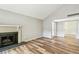 Spacious living room with a brick fireplace, wood floors and vaulted ceiling at 13501 Palmwood Ln # 0, Tampa, FL 33618