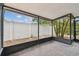 Screened porch with brick-paved flooring and a view of the fenced backyard at 13501 Palmwood Ln # 0, Tampa, FL 33618