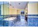 Bathroom featuring a sunken tub, walk-in shower, decorative tile and entrance to living room at 13635 Twin Lakes Ln # 13635, Tampa, FL 33618