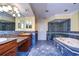 Bathroom with double sink vanity, soaking tub and shower, and blue-tiled floor at 13635 Twin Lakes Ln # 13635, Tampa, FL 33618