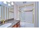 Bathroom with granite countertop, gold fixtures, and tub shower at 13635 Twin Lakes Ln # 13635, Tampa, FL 33618
