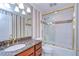 Bathroom with granite countertop, gold fixtures, and tub shower at 13635 Twin Lakes Ln # 13635, Tampa, FL 33618
