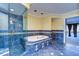 Bathroom featuring a sunken tub, walk-in shower and decorative tile with entrance to living room at 13635 Twin Lakes Ln # 13635, Tampa, FL 33618