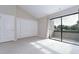 Bedroom features a large sliding glass door to balcony and a closet with bi-fold doors at 13635 Twin Lakes Ln # 13635, Tampa, FL 33618