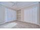 This spacious bedroom features carpeted floors, built-in shelving, and a double-door closet for ample storage at 13635 Twin Lakes Ln # 13635, Tampa, FL 33618