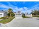 Well-manicured condo community with lush landscaping, long driveways, and attached garages at 13635 Twin Lakes Ln # 13635, Tampa, FL 33618