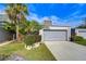 Charming condo with a well maintained lawn, tropical landscaping, and attached one car garage at 13635 Twin Lakes Ln # 13635, Tampa, FL 33618