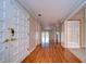 Long hallway with hardwood floors that leads to the living spaces and outdoor lake view deck at 13635 Twin Lakes Ln # 13635, Tampa, FL 33618