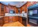 Well-equipped kitchen with wood cabinets, stainless steel appliances, and hardwood flooring at 13635 Twin Lakes Ln # 13635, Tampa, FL 33618