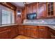 This kitchen features wood cabinets, granite countertops, stainless steel appliances and a tile backsplash at 13635 Twin Lakes Ln # 13635, Tampa, FL 33618