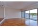 Large living room with hardwood floors and sliding glass doors leading to the deck at 13635 Twin Lakes Ln # 13635, Tampa, FL 33618