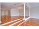 Open-concept living room with hardwood floors, columns, and a raised platform at 13635 Twin Lakes Ln # 13635, Tampa, FL 33618